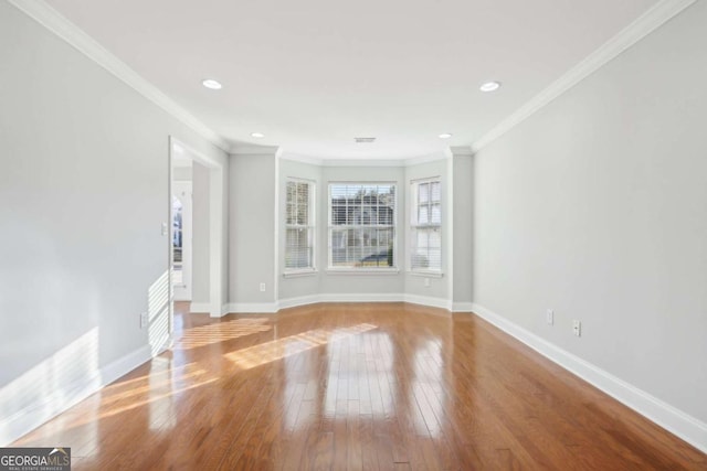 unfurnished living room featuring baseboards, ornamental molding, recessed lighting, visible vents, and hardwood / wood-style floors