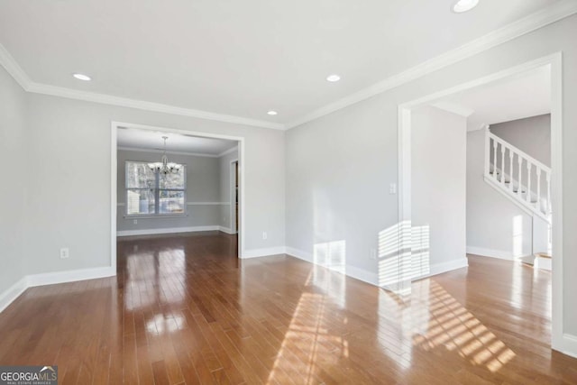 unfurnished living room featuring crown molding, stairway, wood-type flooring, baseboards, and a notable chandelier