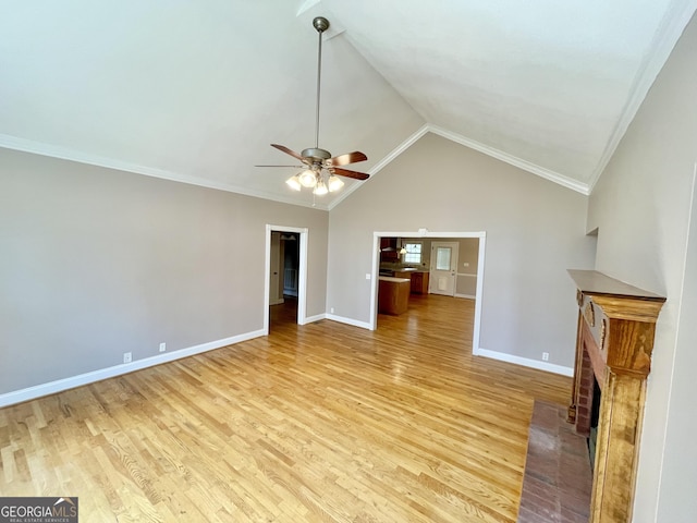 293 N Avery Rd NW, Rome, GA 30165 - unfurnished living room with a ceiling fan, light wood finished floors, a fireplace, and vaulted ceiling
