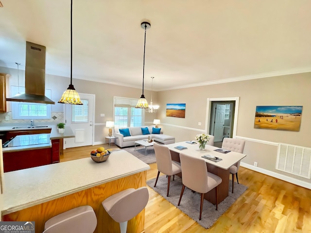 293 N Avery Rd NW, Rome, GA 30165 - dining room with baseboards, ornamental molding, light wood-style flooring, and visible vents