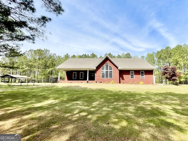 293 N Avery Rd NW, Rome, GA 30165 - rear view of house featuring brick siding and a lawn