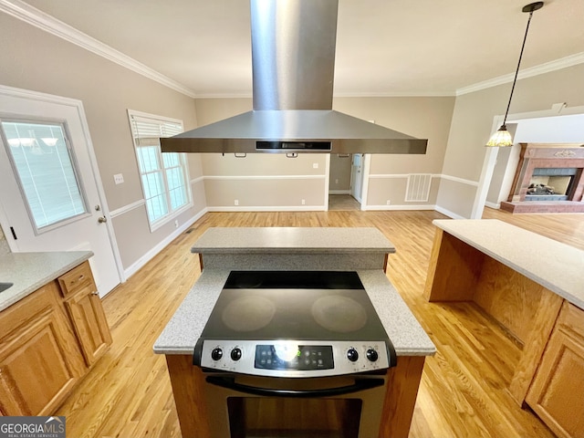 293 N Avery Rd NW, Rome, GA 30165 - kitchen featuring island range hood, a fireplace, open floor plan, light wood-style floors, and ornamental molding