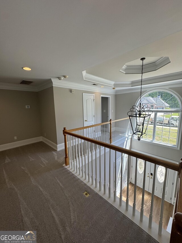 135 Danube Trl, Stockbridge, GA 30281 - hallway featuring a raised ceiling, crown molding, an inviting chandelier, and visible vents