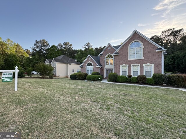 135 Danube Trl, Stockbridge, GA 30281 - traditional-style house with brick siding and a front lawn