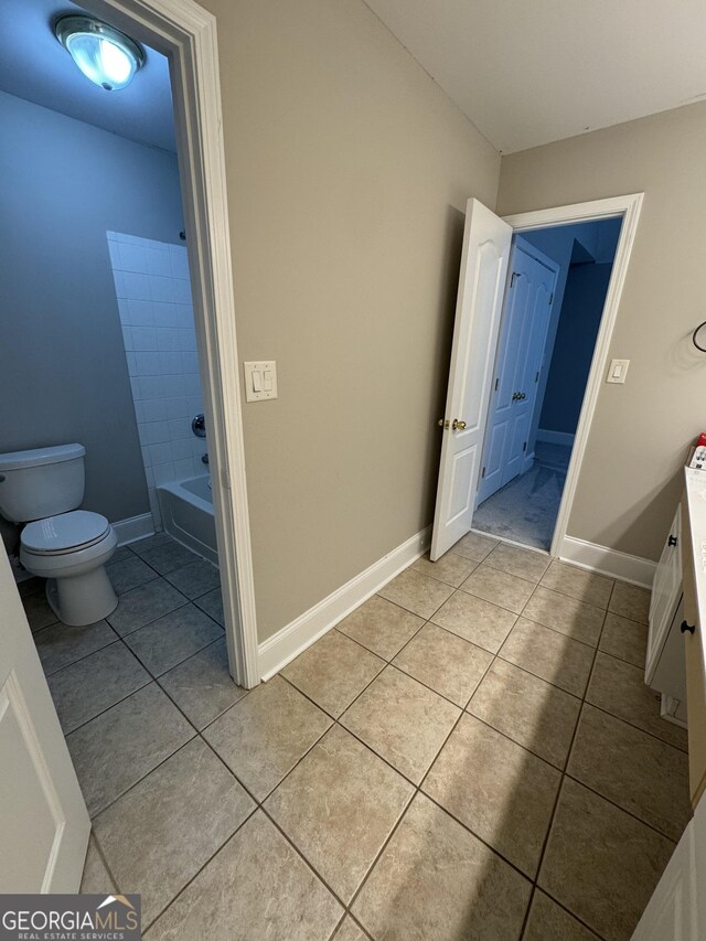 135 Danube Trl, Stockbridge, GA 30281 - bathroom with baseboards, toilet, vanity, shower / bathtub combination, and tile patterned flooring
