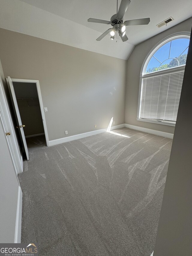 135 Danube Trl, Stockbridge, GA 30281 - carpeted spare room with visible vents, ceiling fan, baseboards, and lofted ceiling