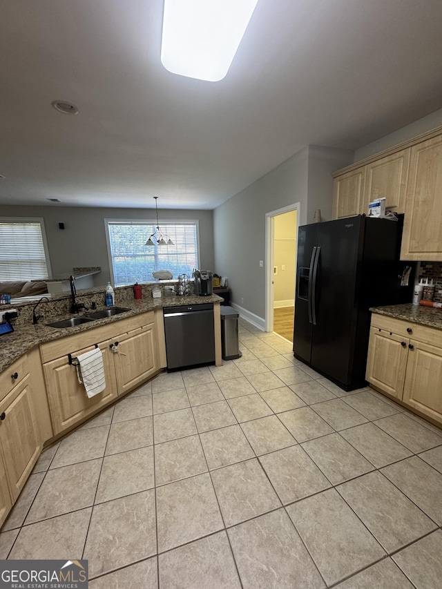 135 Danube Trl, Stockbridge, GA 30281 - kitchen with baseboards, light brown cabinets, black fridge with ice dispenser, dishwashing machine, and a sink