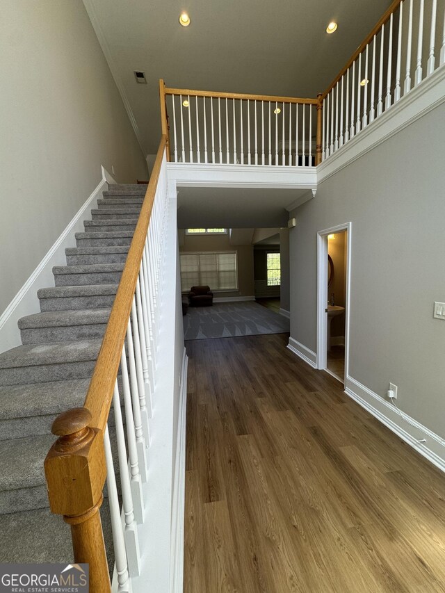 135 Danube Trl, Stockbridge, GA 30281 - staircase featuring crown molding, wood finished floors, baseboards, and recessed lighting