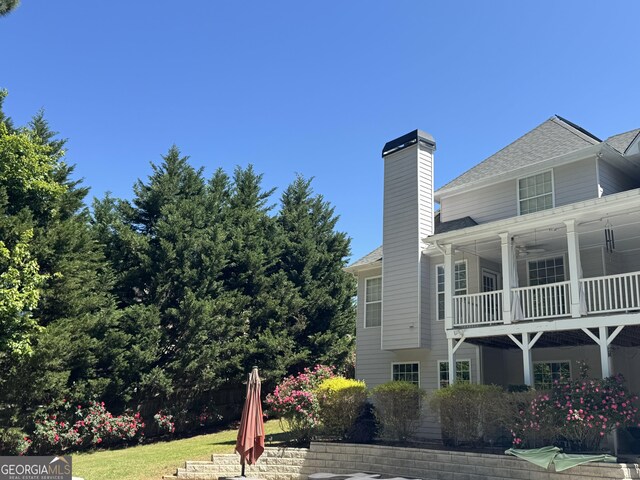 135 Danube Trl, Stockbridge, GA 30281 - view of side of home featuring roof with shingles and a chimney