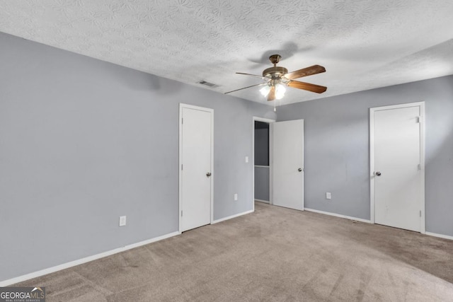 2998 Kenville Ln, Decatur, GA 30034 - unfurnished bedroom featuring a textured ceiling, baseboards, carpet, and visible vents