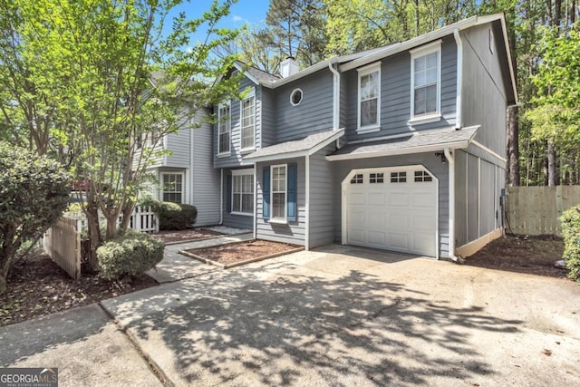 2998 Kenville Ln, Decatur, GA 30034 - traditional-style house with an attached garage, a chimney, concrete driveway, and fence