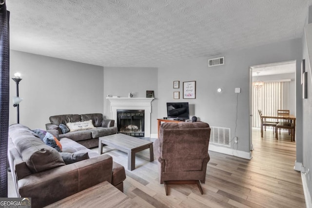 2998 Kenville Ln, Decatur, GA 30034 - living area with light wood-style floors, visible vents, and a textured ceiling