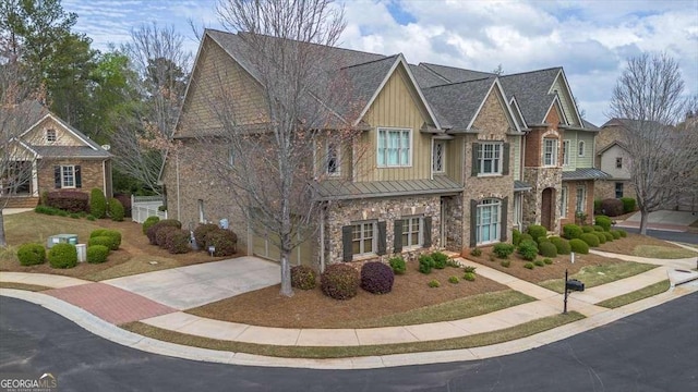 1786 Cambridge Sq, Watkinsville, GA 30677 - view of front of property featuring a standing seam roof, stone siding, metal roof, a garage, and driveway
