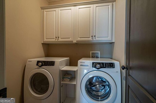1786 Cambridge Sq, Watkinsville, GA 30677 - clothes washing area featuring independent washer and dryer and cabinet space