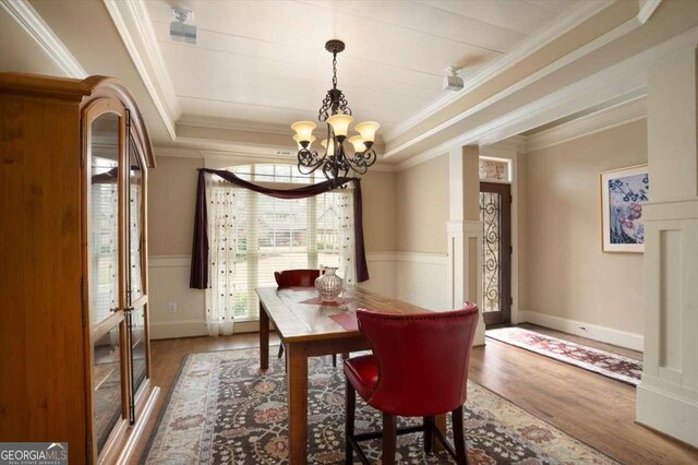1786 Cambridge Sq, Watkinsville, GA 30677 - dining room featuring a raised ceiling, wood finished floors, an inviting chandelier, and ornamental molding