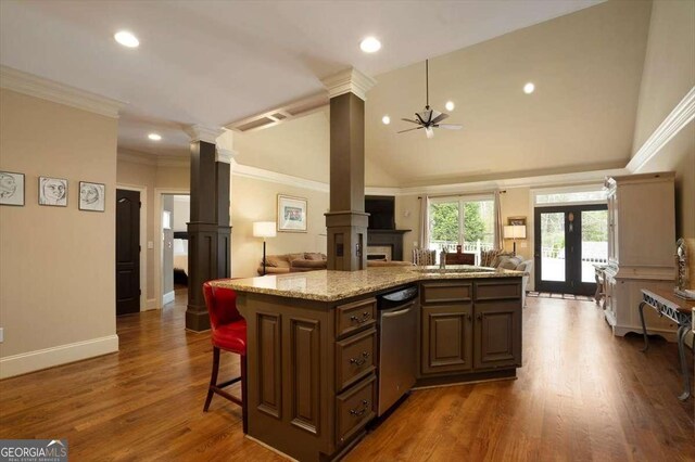 1786 Cambridge Sq, Watkinsville, GA 30677 - kitchen with dishwasher, open floor plan, an island with sink, ornate columns, and light stone counters
