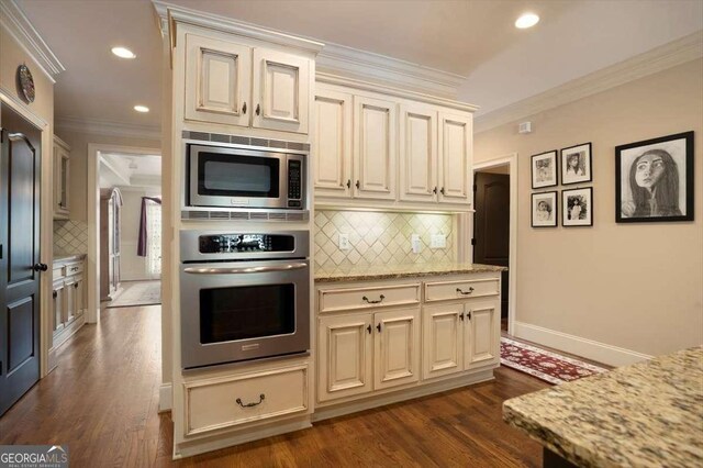 1786 Cambridge Sq, Watkinsville, GA 30677 - kitchen featuring crown molding, appliances with stainless steel finishes, cream cabinets, and dark wood finished floors