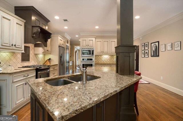1786 Cambridge Sq, Watkinsville, GA 30677 - kitchen with baseboards, visible vents, a spacious island, stainless steel appliances, and a sink