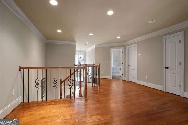 1786 Cambridge Sq, Watkinsville, GA 30677 - hall with ornamental molding, an upstairs landing, wood finished floors, and recessed lighting