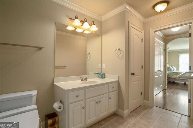 1786 Cambridge Sq, Watkinsville, GA 30677 - bathroom with vanity, baseboards, tile patterned flooring, crown molding, and toilet