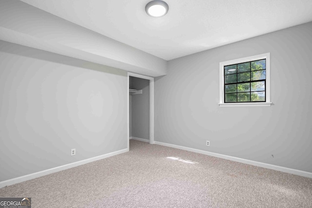 unfurnished bedroom featuring baseboards, a closet, and carpet