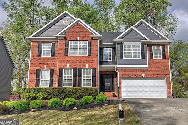 view of front of property featuring an attached garage, driveway, and brick siding