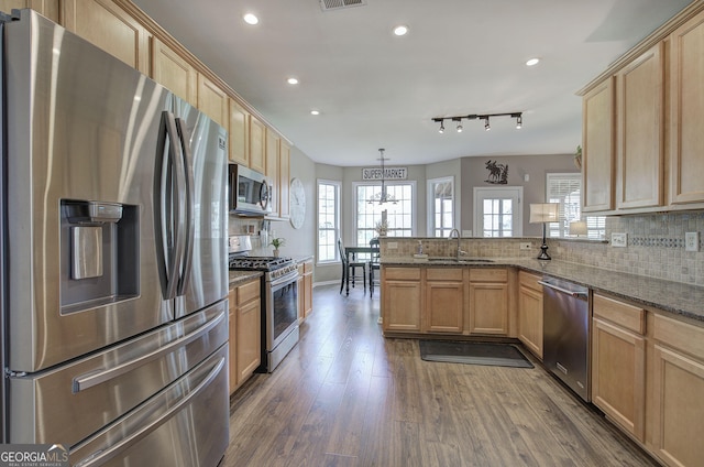 kitchen with recessed lighting, tasteful backsplash, light brown cabinetry, and appliances with stainless steel finishes