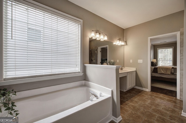 full bath with a bath, vanity, ensuite bath, a shower, and baseboards