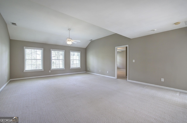 unfurnished room with light colored carpet, visible vents, baseboards, and a ceiling fan
