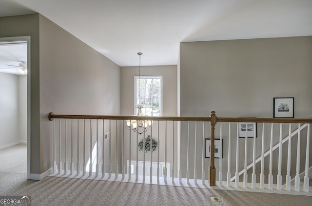 corridor with carpet flooring and baseboards