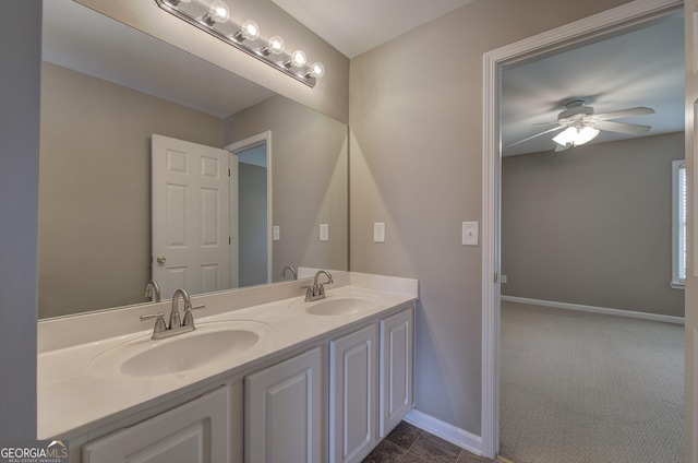 bathroom featuring double vanity, baseboards, a sink, and ceiling fan