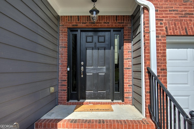 entrance to property featuring brick siding