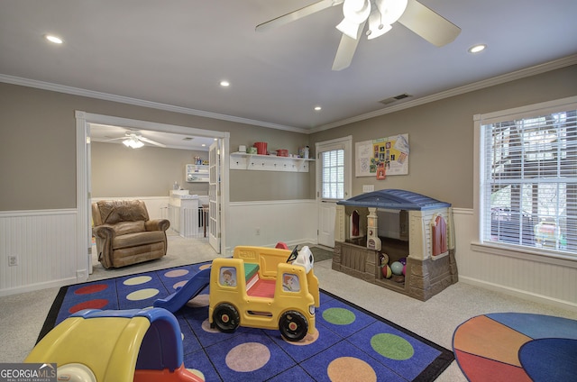 rec room with a ceiling fan, crown molding, recessed lighting, wainscoting, and carpet flooring