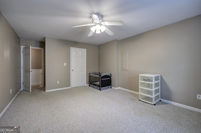 unfurnished bedroom with baseboards, a ceiling fan, and carpet floors