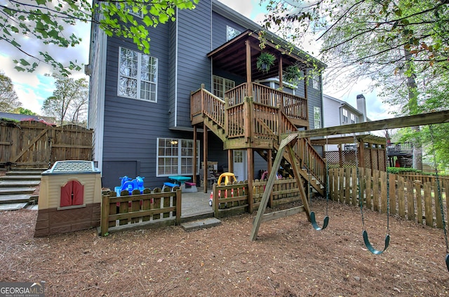 view of play area featuring fence, a patio, a gate, and stairway