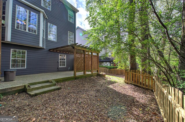 view of yard featuring a patio, a pergola, and a fenced backyard