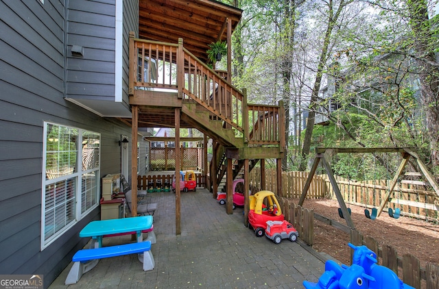 exterior space featuring a patio, stairway, and fence