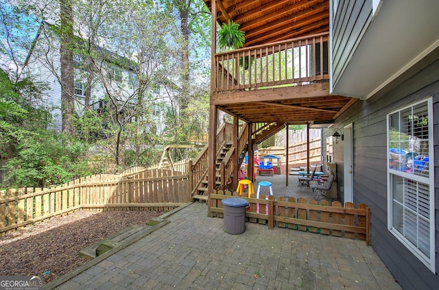 view of patio / terrace featuring stairs and a fenced backyard