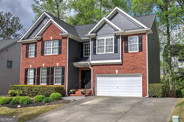 view of front of home with an attached garage, concrete driveway, and brick siding