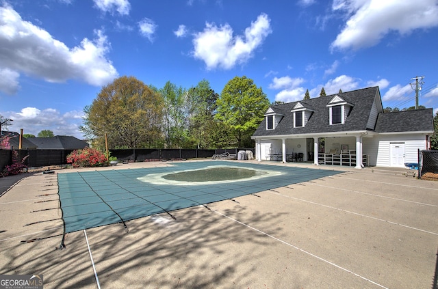 view of swimming pool featuring a patio, a fenced in pool, and fence