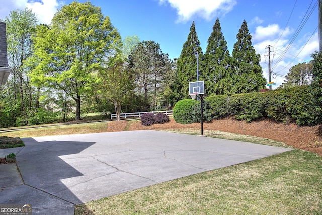 view of basketball court featuring community basketball court, a yard, and fence