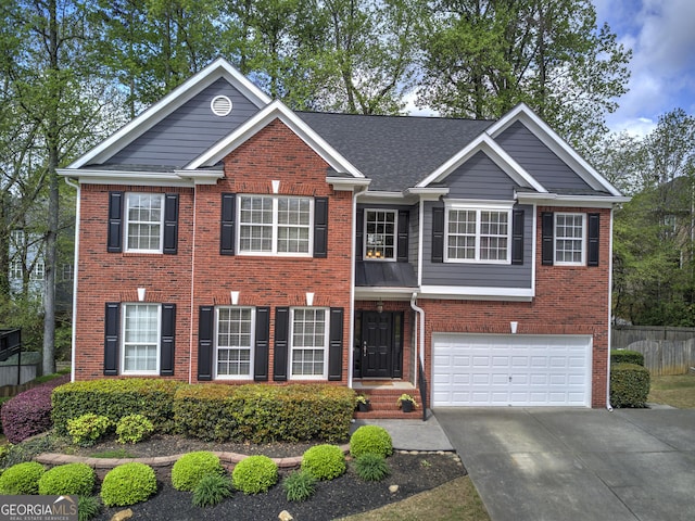 view of front of property featuring concrete driveway, roof with shingles, brick siding, a garage, and fence
