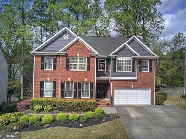 view of front of home with a garage, brick siding, driveway, and fence