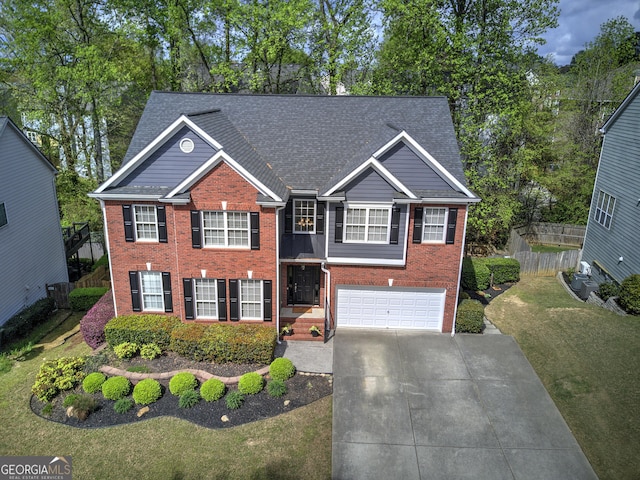view of front facade featuring concrete driveway, cooling unit, brick siding, a garage, and fence