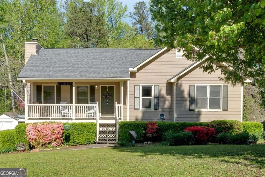 198 Wiley Dr, Douglasville, GA 30134 - ranch-style house with covered porch, a front yard, a chimney, and roof with shingles