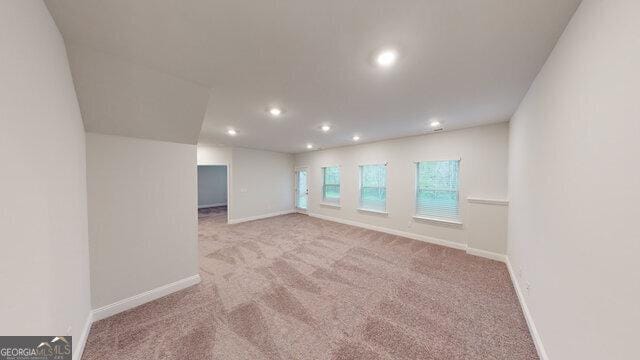 carpeted spare room with baseboards and recessed lighting
