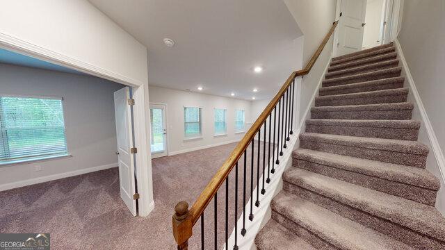 stairs featuring carpet flooring, baseboards, and recessed lighting