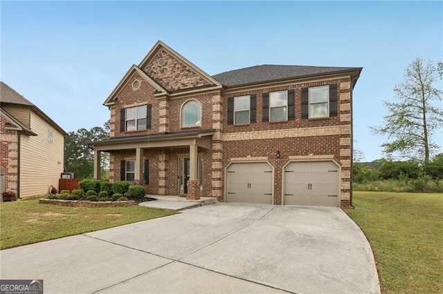 traditional-style home with a garage, concrete driveway, a front lawn, and brick siding