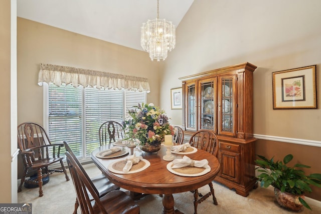 2545 Amberbrook Ln, Grayson, GA 30017 - dining area with high vaulted ceiling, carpet flooring, and an inviting chandelier