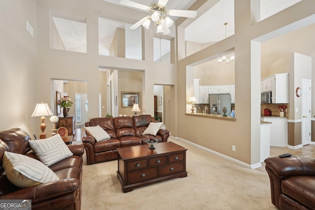 2545 Amberbrook Ln, Grayson, GA 30017 - living room featuring light carpet, a high ceiling, baseboards, and a ceiling fan
